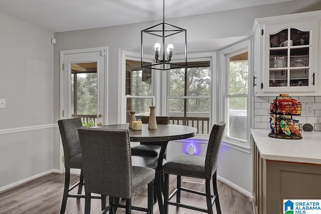 dining space featuring a notable chandelier and light hardwood / wood-style floors