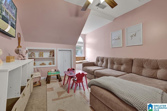 carpeted living room with vaulted ceiling and ceiling fan