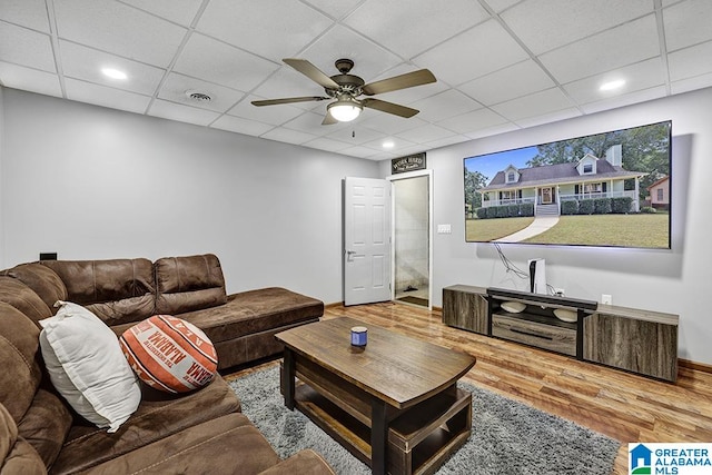 living room featuring ceiling fan, hardwood / wood-style flooring, and a paneled ceiling