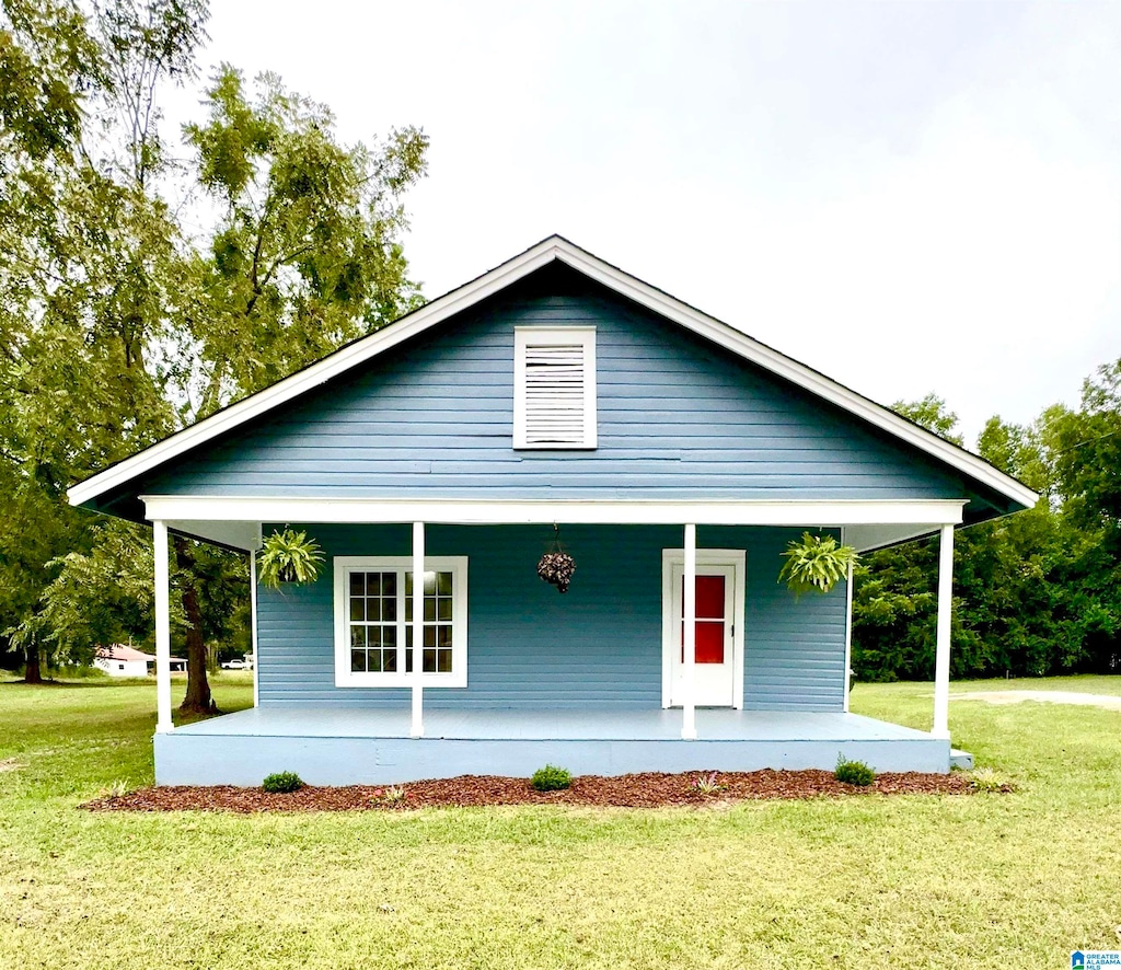 view of front facade featuring covered porch and a front lawn