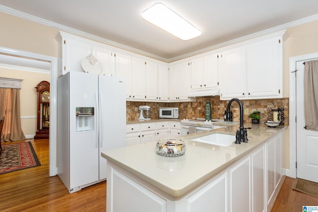 kitchen featuring custom exhaust hood, ornamental molding, white appliances, white cabinetry, and light wood-type flooring