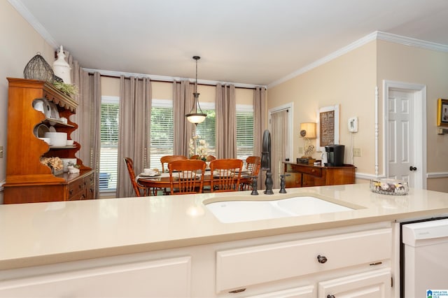 kitchen with white dishwasher, decorative light fixtures, crown molding, and sink