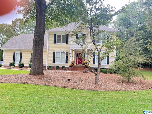 colonial inspired home with a front yard