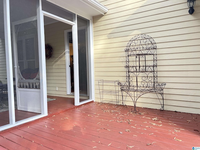 wooden deck with a sunroom