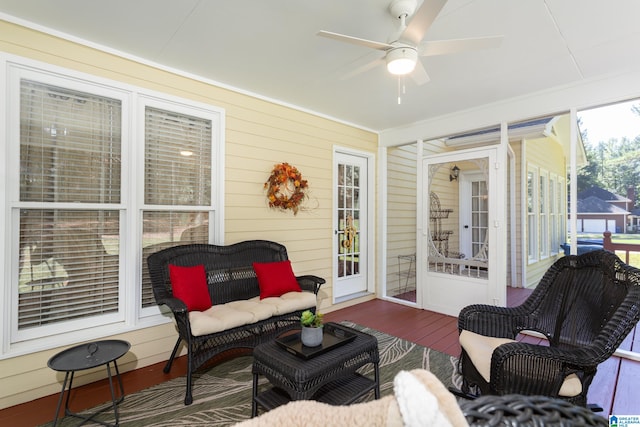 sunroom featuring ceiling fan