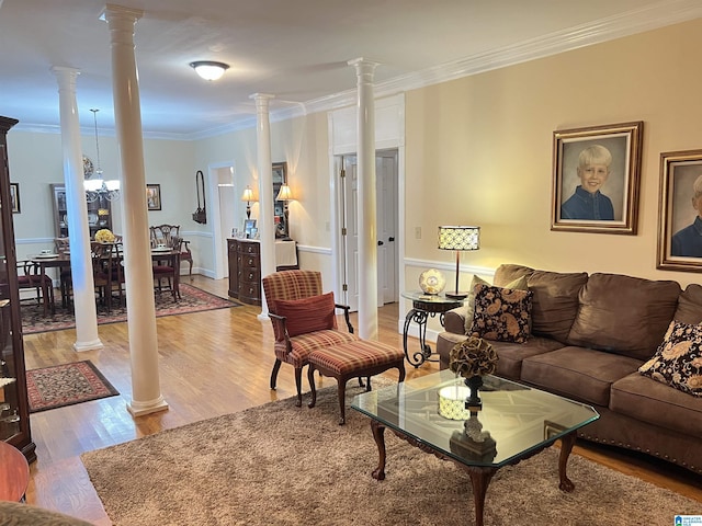 living room with ornamental molding, light wood-style flooring, and decorative columns