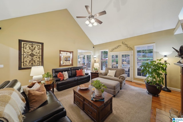 living room with ceiling fan, light hardwood / wood-style flooring, french doors, and high vaulted ceiling