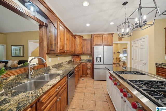 kitchen with decorative light fixtures, appliances with stainless steel finishes, crown molding, and sink