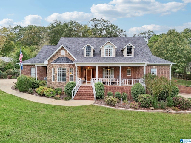 new england style home featuring a front lawn and covered porch