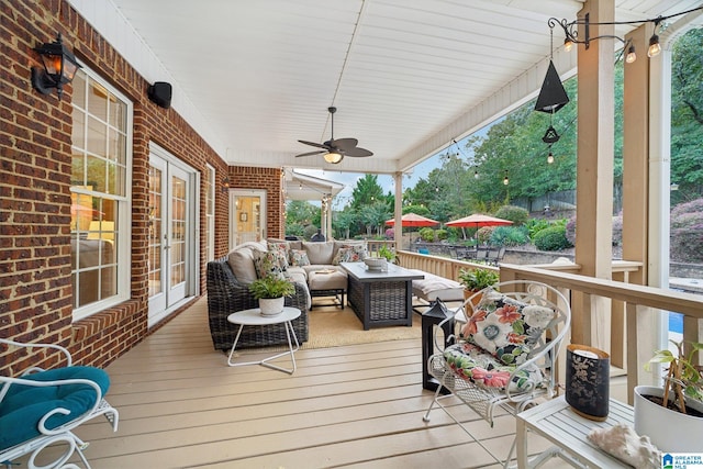 deck with an outdoor hangout area and ceiling fan