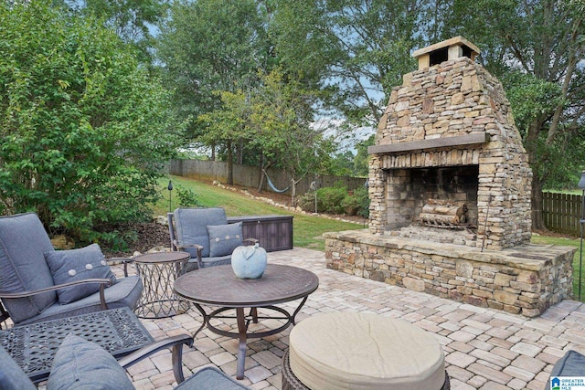 view of patio featuring an outdoor stone fireplace