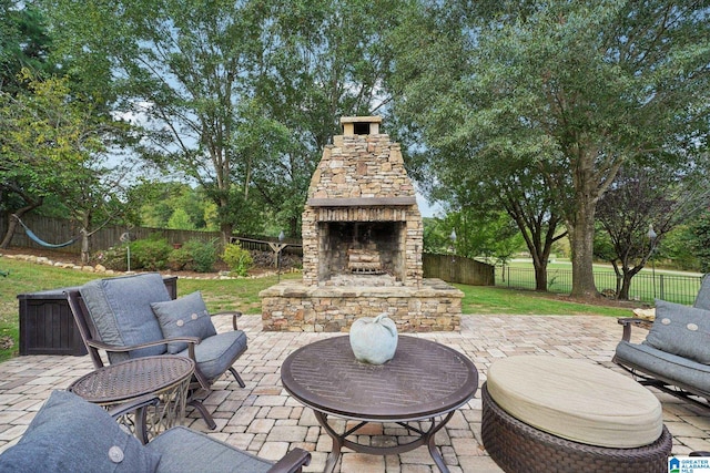 view of patio featuring an outdoor stone fireplace