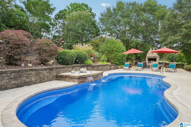 view of swimming pool featuring pool water feature and a patio area