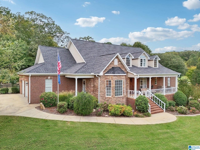 cape cod-style house featuring covered porch, a front yard, and a garage