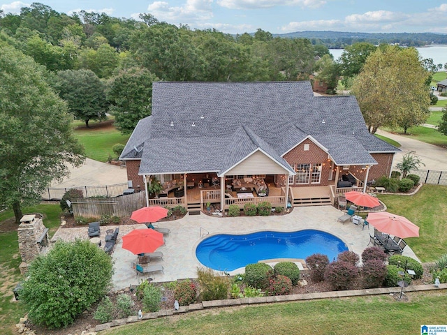 view of swimming pool with a deck, a yard, and a patio