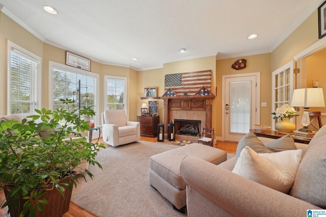 living room with light wood-type flooring, a fireplace, and ornamental molding