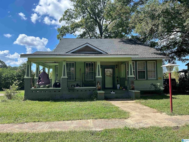 bungalow with a front lawn and a porch