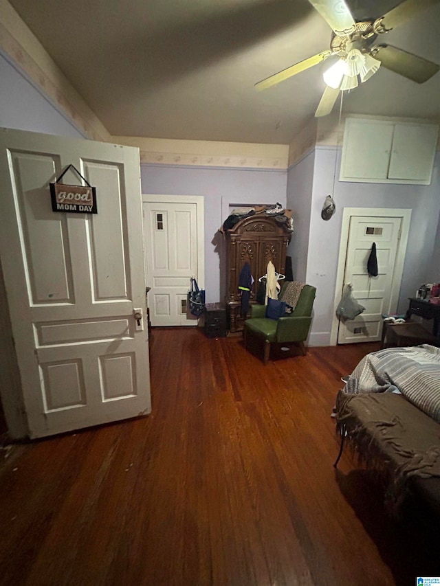 bedroom with ceiling fan and dark wood-type flooring