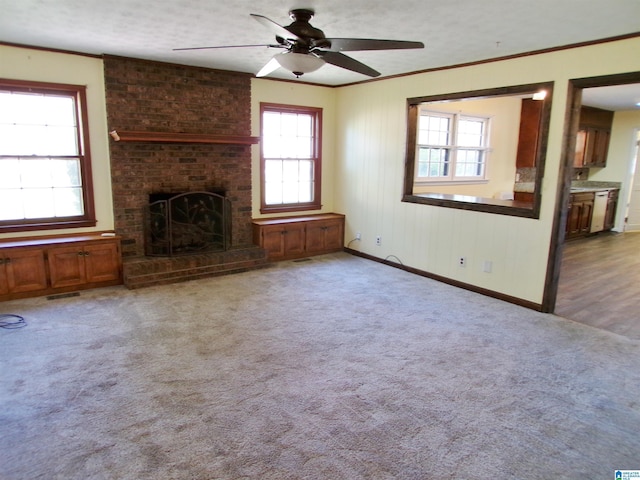 unfurnished living room featuring baseboards, a fireplace, a ceiling fan, visible vents, and carpet