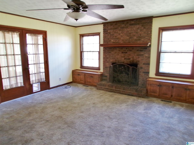 unfurnished living room with light colored carpet, a ceiling fan, ornamental molding, visible vents, and french doors