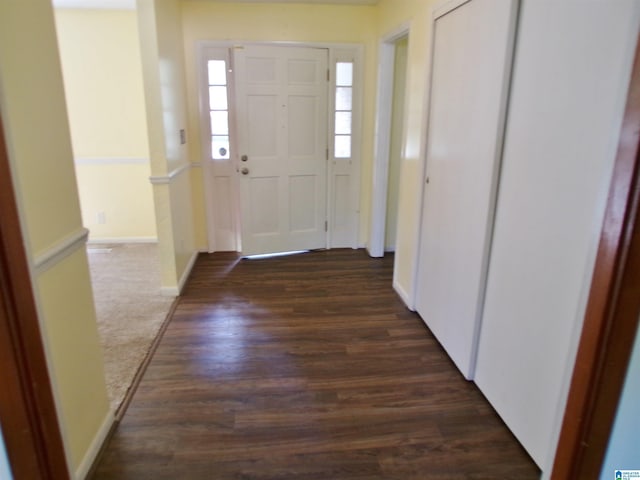interior space featuring dark wood-type flooring and baseboards
