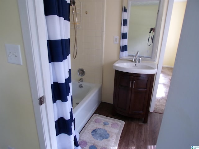 bathroom featuring shower / bathtub combination with curtain, vanity, and wood finished floors