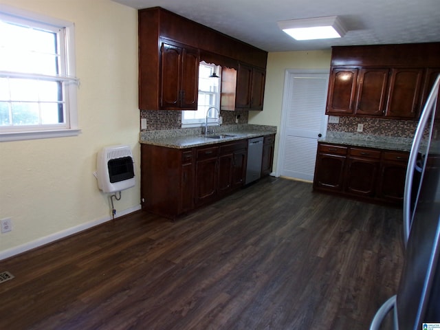 kitchen with a sink, tasteful backsplash, heating unit, and dishwashing machine