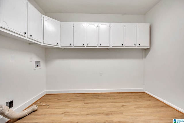 clothes washing area featuring cabinets, light hardwood / wood-style flooring, and hookup for a washing machine