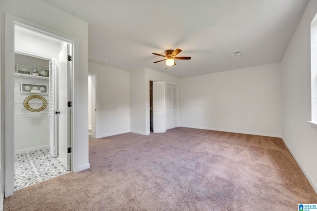 unfurnished bedroom featuring light carpet and ceiling fan