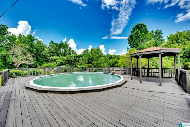 view of pool with a deck and a gazebo