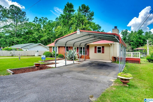 view of front of house with a wooden deck, a front lawn, and a carport