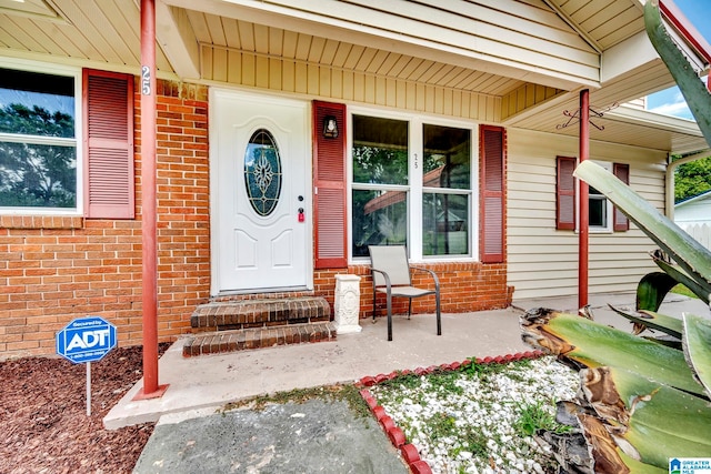 view of exterior entry featuring a porch