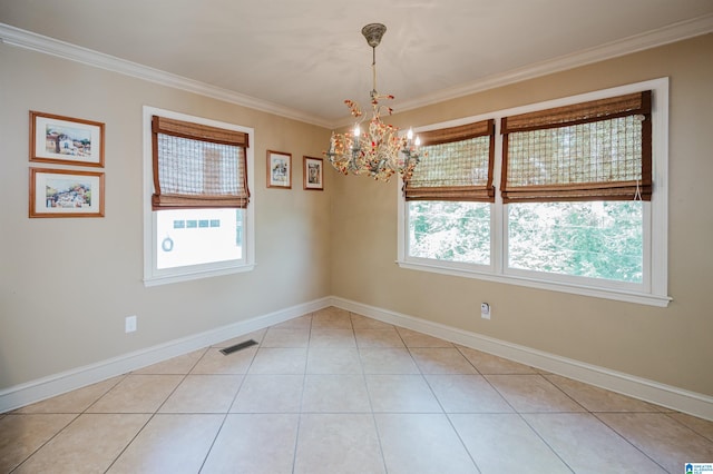 tiled empty room with a healthy amount of sunlight, ornamental molding, and a notable chandelier