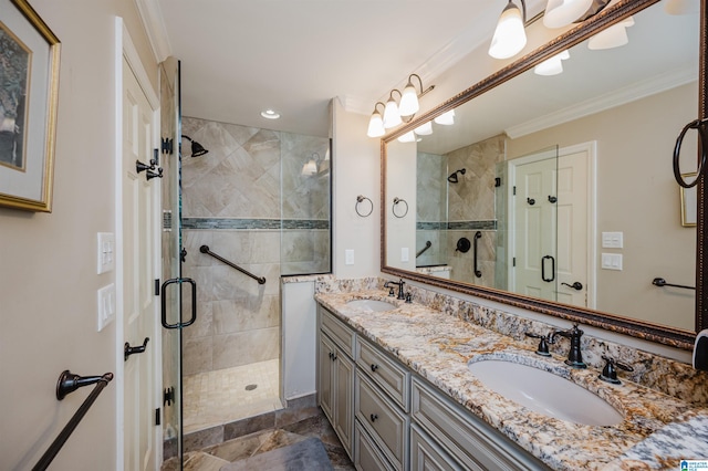 bathroom featuring vanity, ornamental molding, and an enclosed shower