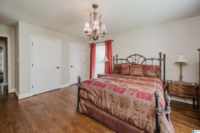 bedroom featuring an inviting chandelier and hardwood / wood-style flooring