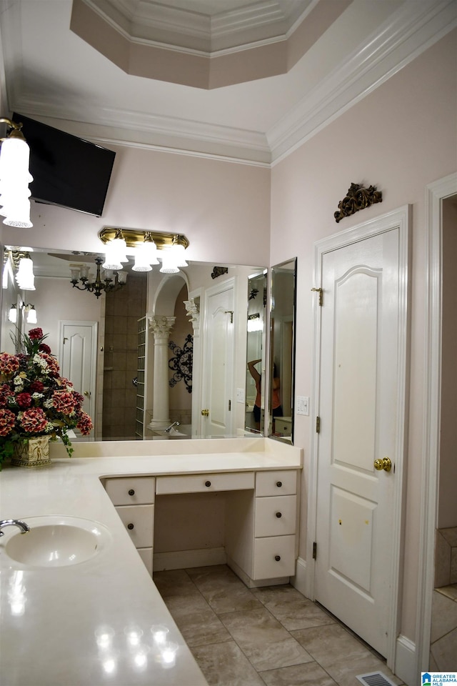 bathroom featuring vanity, crown molding, and a tray ceiling