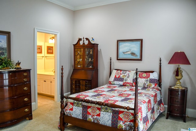 carpeted bedroom with ornamental molding, sink, and connected bathroom