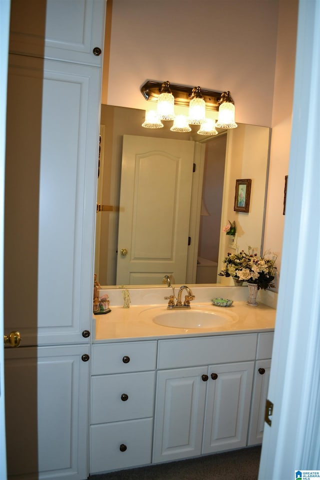 bathroom featuring vanity and toilet