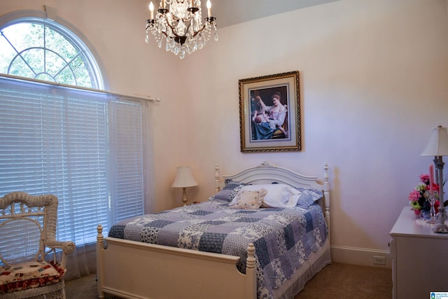 bedroom with a notable chandelier and carpet flooring