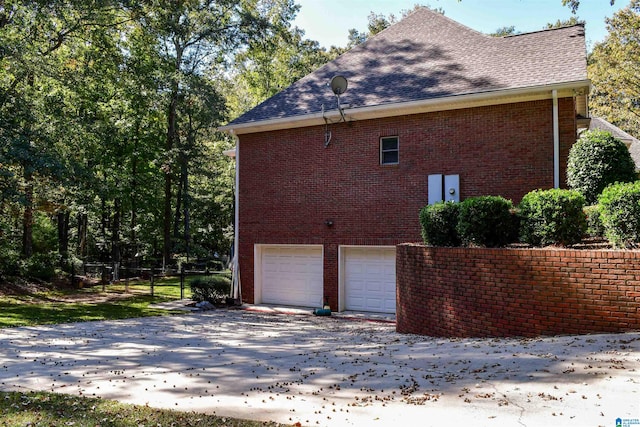 view of side of home with a garage