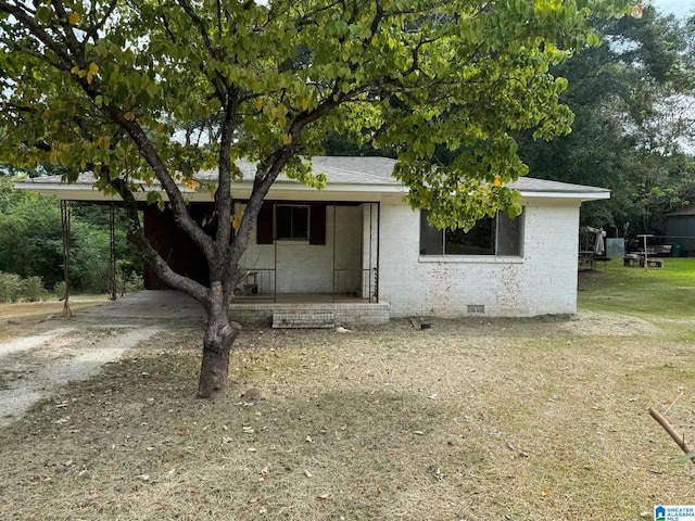 view of front of house featuring a front yard, covered porch, and a carport