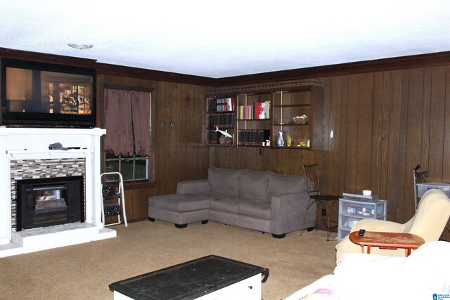 carpeted living room with crown molding, a fireplace, and wood walls