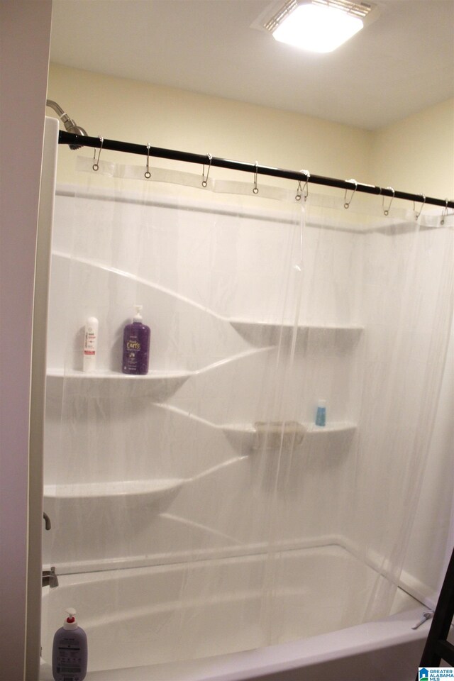 bathroom featuring shower / tub combo with curtain