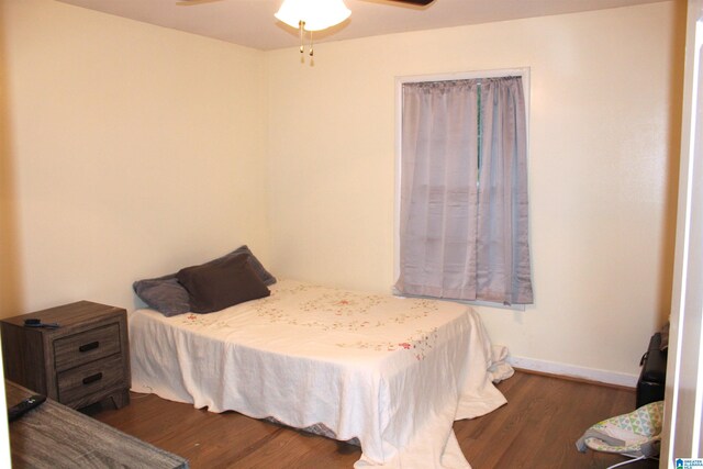 bedroom with ceiling fan and dark hardwood / wood-style flooring