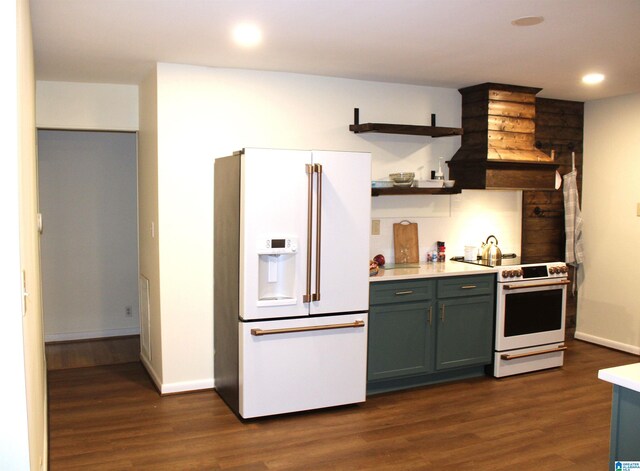 kitchen featuring premium range hood, white appliances, and dark hardwood / wood-style flooring