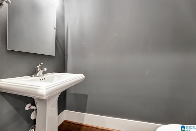 bathroom with wood-type flooring and sink