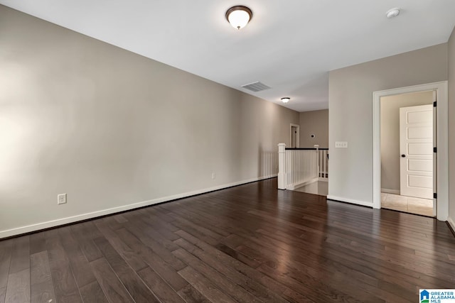 spare room with dark wood-type flooring