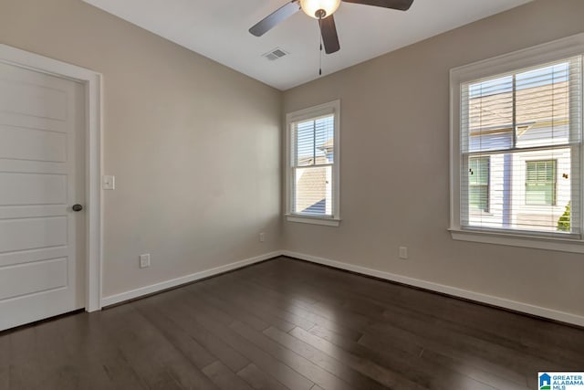 spare room with dark hardwood / wood-style floors and ceiling fan