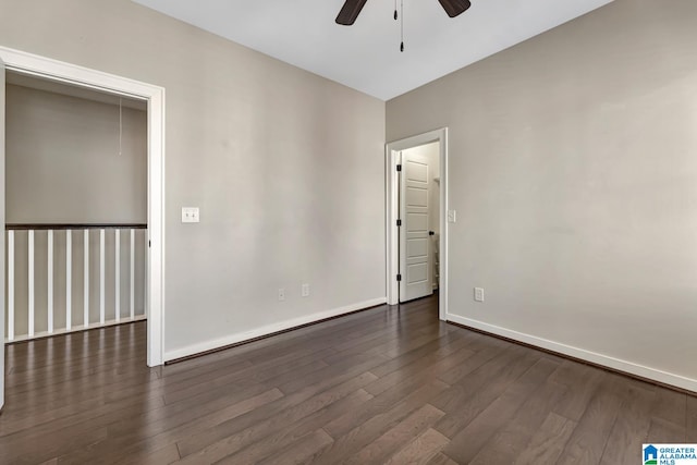 unfurnished room with dark hardwood / wood-style flooring and ceiling fan