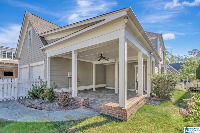 view of front facade featuring a garage, a front yard, ceiling fan, and a patio area